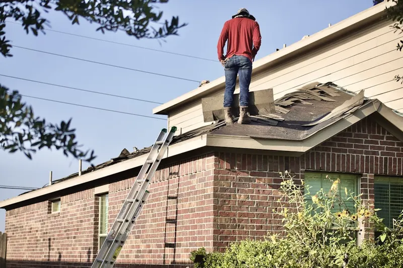 Professional roofer working on a residential roof in Wyandotte